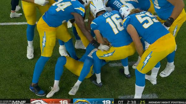 Chargers players around Dustin Hopkins