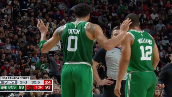 Jayson Tatum with his arms up