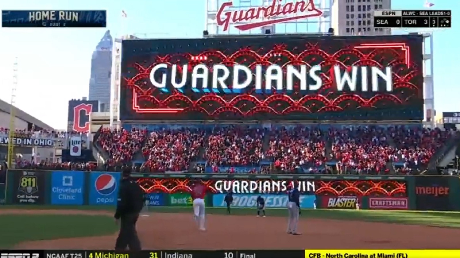 Cleveland Guardians' Oscar Gonzalez celebrates as he runs the