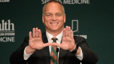 Mark Richt flashes the Miami symbol