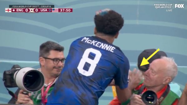 Weston McKennie wipes his hands on a photographer's bib