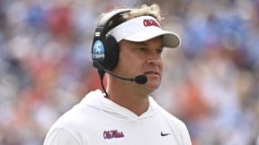 Lane Kiffin wearing a headset