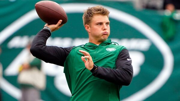 Zach Wilson holds up a ball