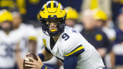 Michigan quarterback JJ McCarthy rolls out of the pocket