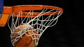 A basketball going through the net