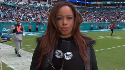 Pam Oliver holding a mic