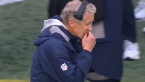 Pete Carroll holding his gum