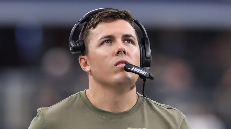 Kellen Moore wearing a headset while coaching