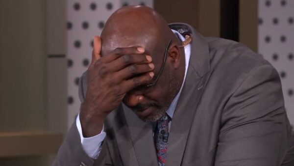 Shaq covering his forehead