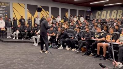 Tim Brewster in front of his players