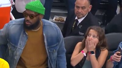 A young girl surprised to sit next to LeBron James