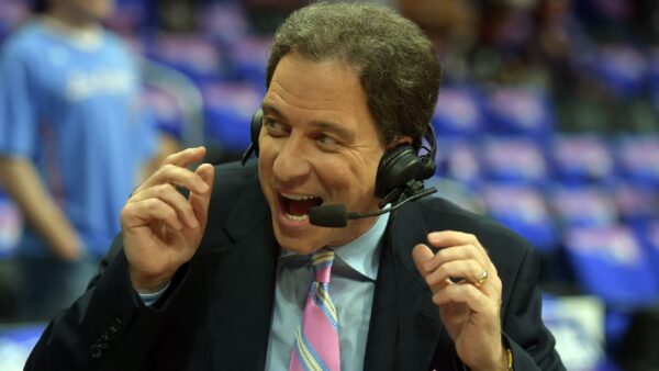 Kevin Harlan wearing a headset