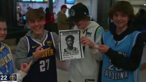 Nuggets fans hold up a Joel Embiid sign