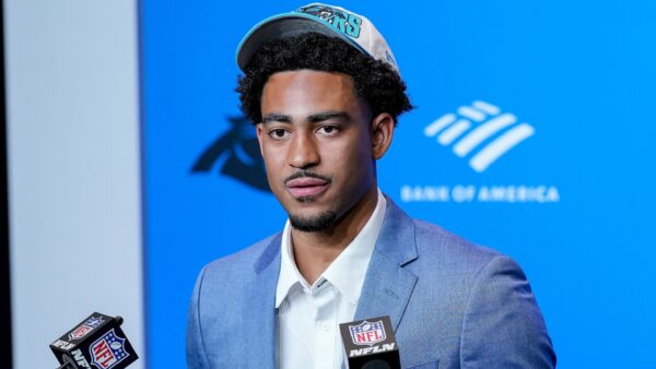 Bryce Young wearing a Panthers hat