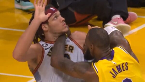 LeBron with his forearm at Aaron Gordon neck