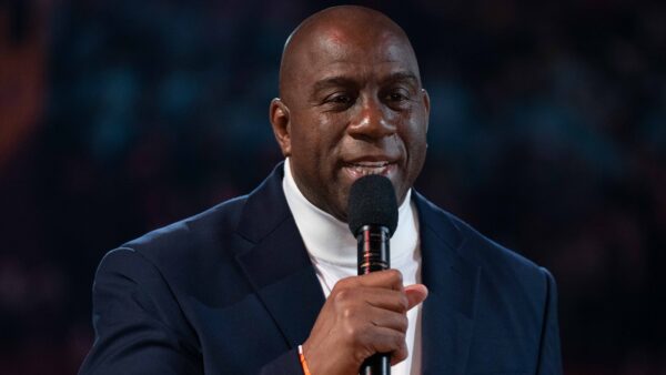 Magic Johnson holds a microphone