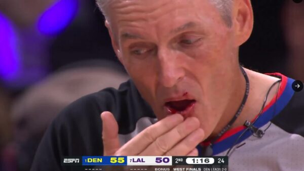 Scott Foster touching his lip