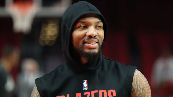 Damian Lillard warms up before a game while wearing a Blazers hoodie