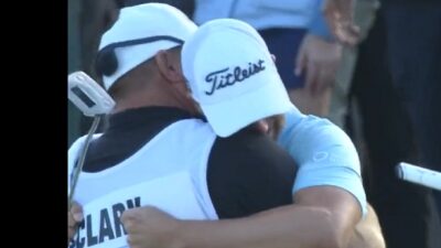 Wyndham Clark hugs his caddie