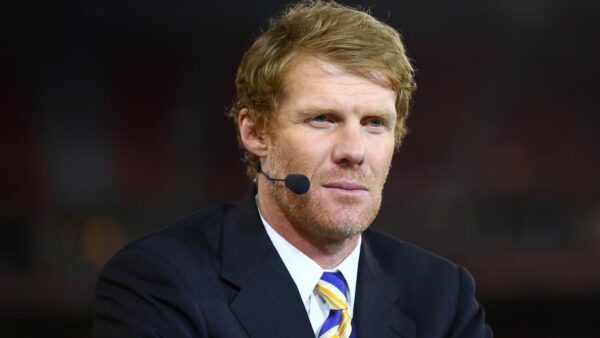 Alexi Lalas with a microphone in front of his face