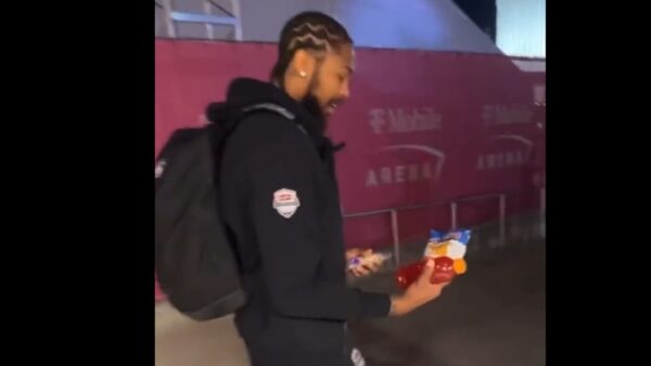 Brandon Ingram holds bags of food