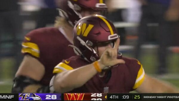 Joey Slye holds up an L