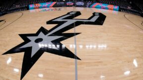 The Spurs logo at center court