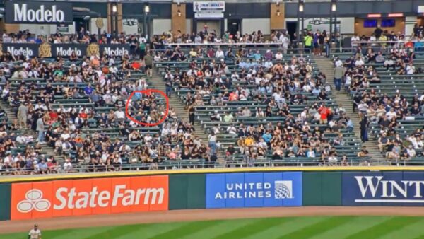 People in the outfield at a White Sox game