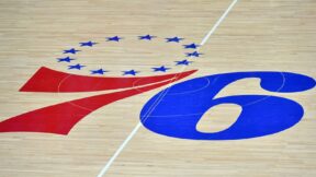 The Philadelphia 76ers logo at center court