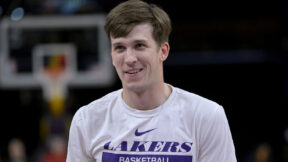 Austin Reaves smirking while wearing a Lakers shirt