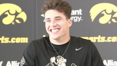 Cade McNamara laughs at a press conference
