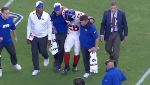 Saquon Barkley is helped off the field