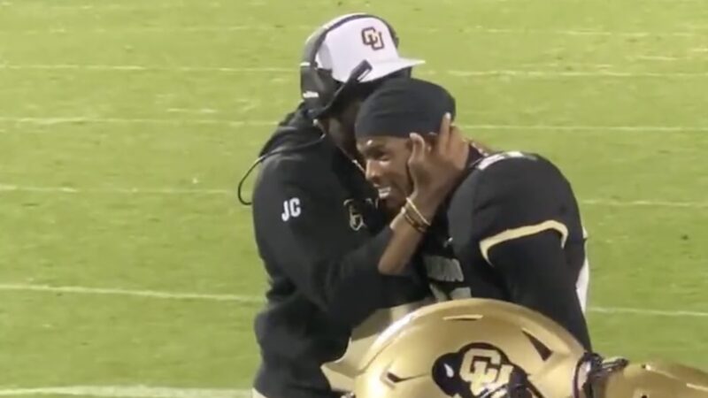 Deion Sanders and Shilo Sanders sharing a moment after the latter's pick-6 during Colorado-Colorado State