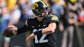 Cade McNamara throwing a pass