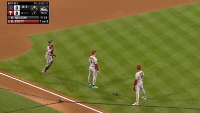 Diamondbacks players stand on infield