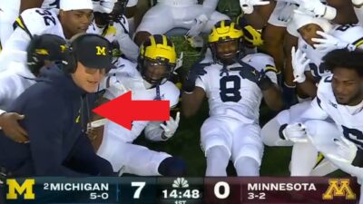 Jim Harbaugh next to his defense