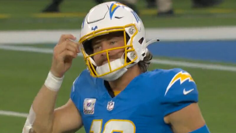 Justin Herbert touches his helmet