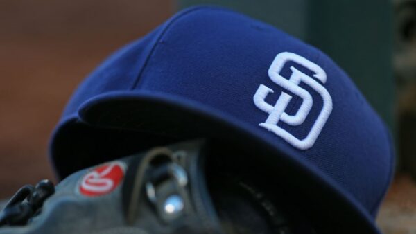 A San Diego Padres hat resting on a glove