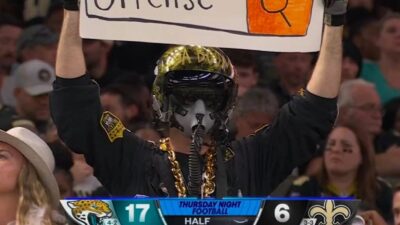 Saints fan holds up a sign