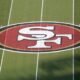 The San Francisco 49ers logo at midfield