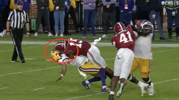 Jayden Daniels taking a hard hit from Dallas Turner during an LSU-Alabama game