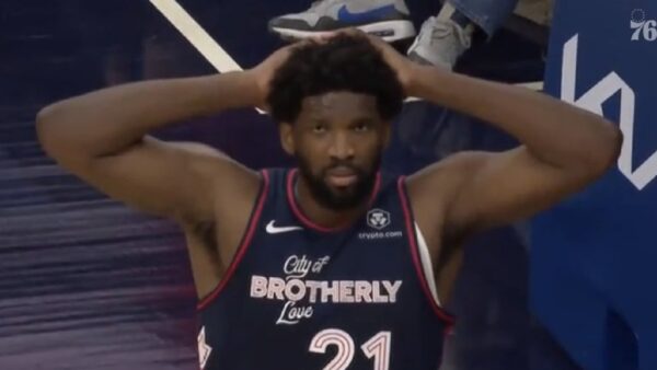 Joel Embiid with his hands behind his head