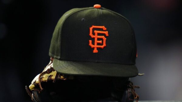 A San Francisco Giants cap on top of a glove