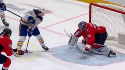 Zach Benson with the puck between his legs