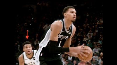 Victor Wembanyama driving past Giannis Antetokounmpo during a Spurs-Bucks game