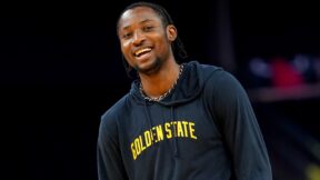 Jonathan Kuminga grinning while warming up