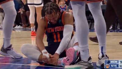 Knicks star Jalen Brunson grabbing at his ankle