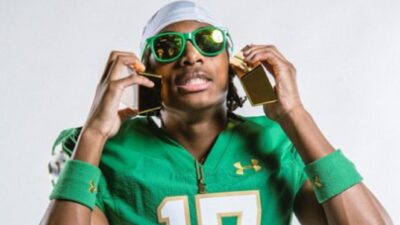 Elijah Burress holds money up