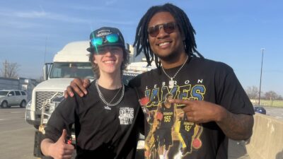 Anthony Richardson poses with a stranded motorist