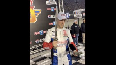 Denny Hamlin holding a sword and a cucumber